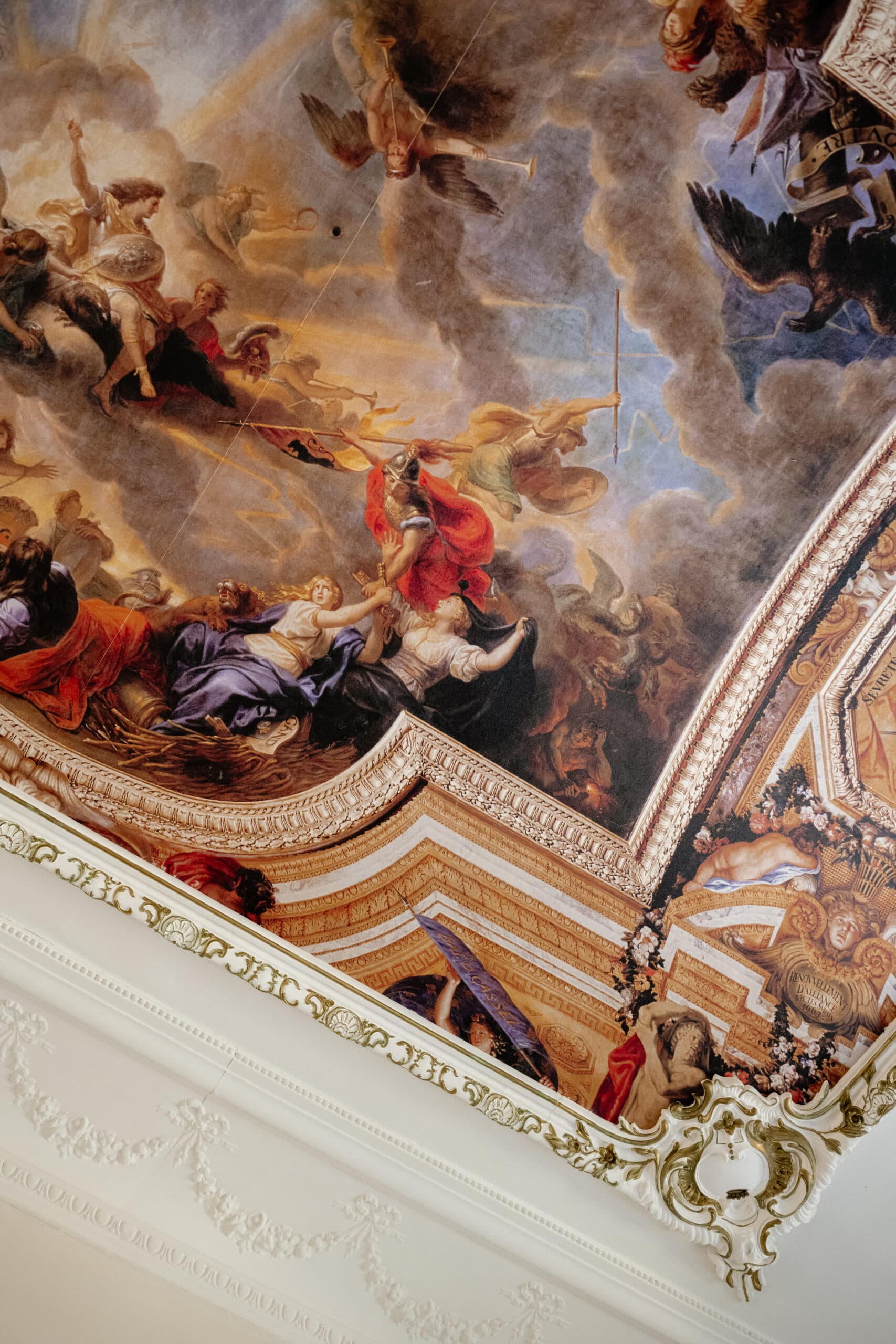 A painted ceiling with ornate plasterwork
